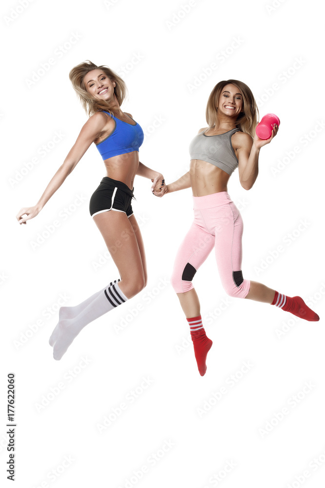 two jumping fitness girl on white background two jumping fitness girl on white background