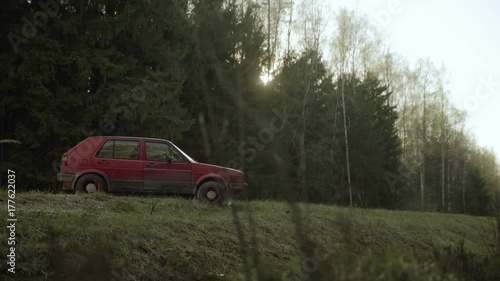 Abandoned old car on the forest road