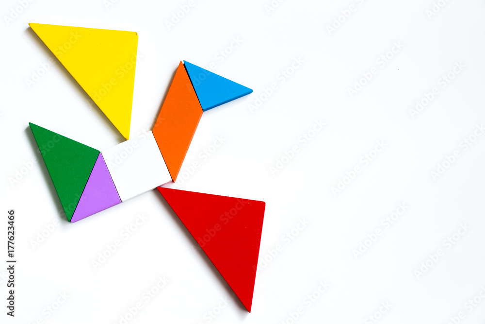 Colorful wood tangram puzzle in flying bird shape on white background Colorful wood tangram puzzle in flying bird shape on white background