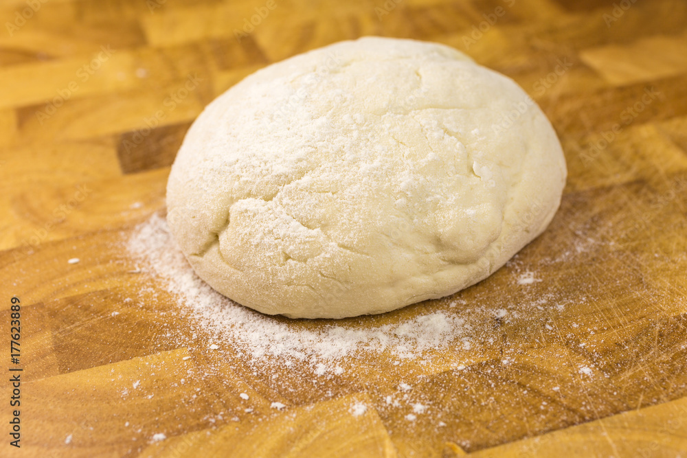 ball of pizza dough with dusting of flour ball of pizza dough with dusting of flour