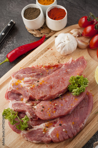 Preparing of pork meal on wooden tray 