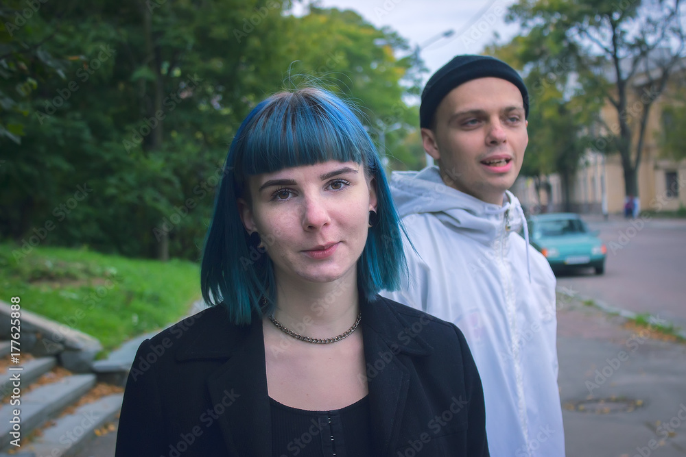 Young man and blue haired girl asking for some money at street Young man and blue haired girl asking for some money at street
