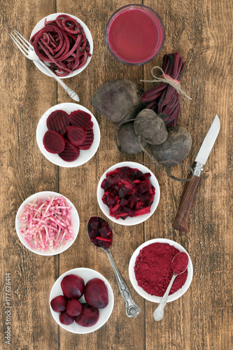 Beetroot vegetable health food with smoothie juice drink, fresh, powder, sliced, pickled and shredded on oak. Contains antioxidants, anthocyanins and vitamins and has medicinal properties.