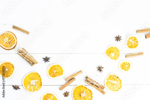 ingredients of spices and oranges for mulled wine on a white wooden table. background. copyspace