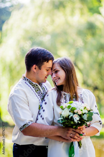 Beautiful couple in clothes with embroidery hugs