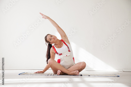 a pregnant woman is engaged in gymnastics and yoga photo