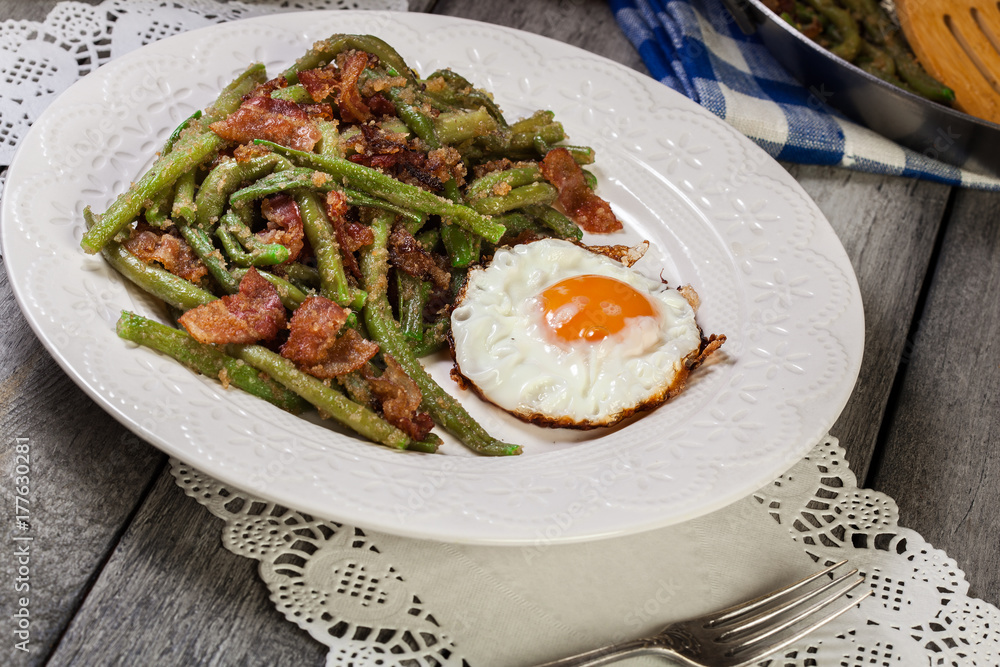 Healthy sauteed green beans with bacon and fried egg