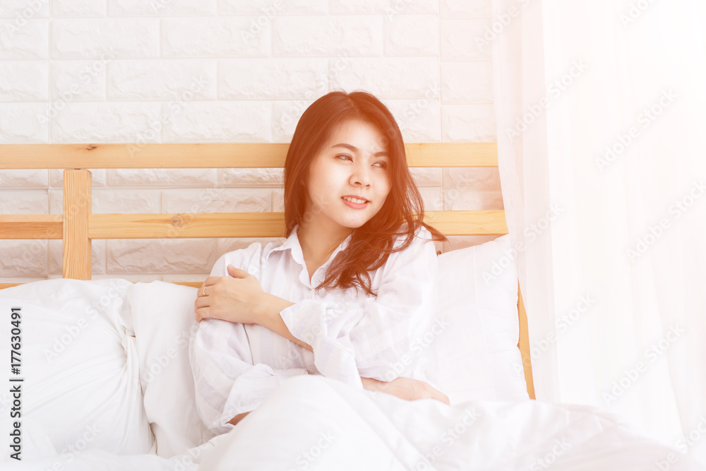 Woman on bed in bedroom in early moring. Woman on bed in bedroom in early moring.
