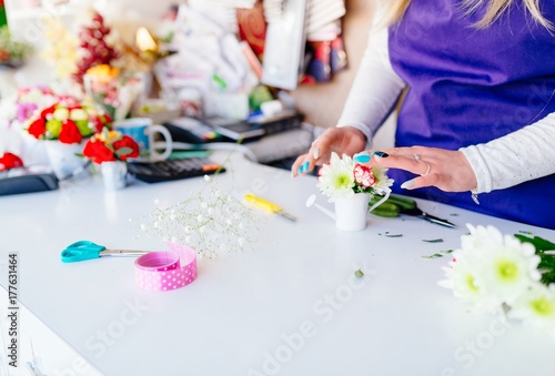 Florist woman making a miniature flower composition