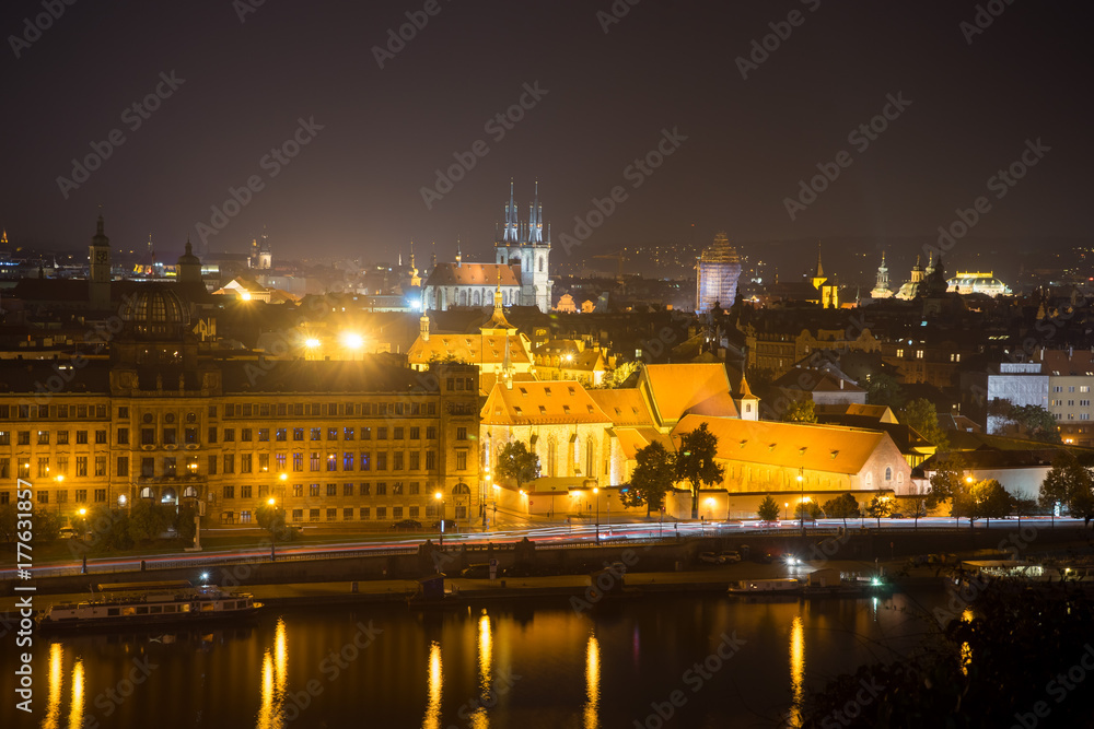 The center of Prague at night. Embankment of Vltava. The Church of the Virgin Mary in front of Tyn