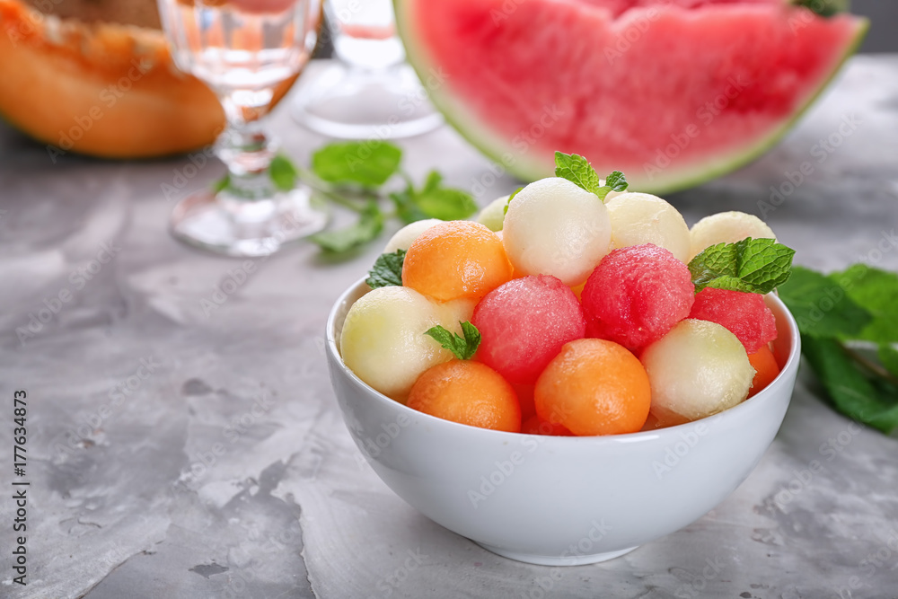 Bowl with fresh fruit balls on table Bowl with fresh fruit balls on table
