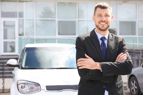 Salesman standing near new ...