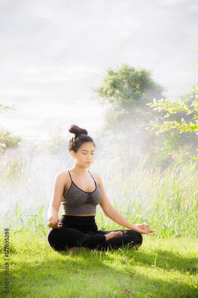 Young woman practicing yoga Everyday Yoga helps in concentration, meditation,breath, shape, strength, help skin brighten. Among the Dharma Air in bright days Young woman practicing yoga Everyday Yoga helps in concentration, meditation,breath, shape, strength, help skin brighten. Among the Dharma Air in bright days