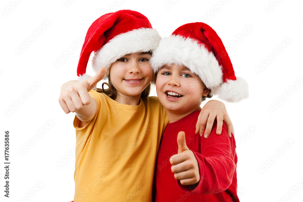 Christmas time - girl and boy with Santa Claus Hat showing OK sign Christmas time - girl and boy with Santa Claus Hat showing OK sign