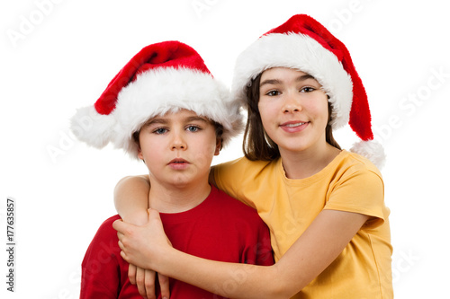 Christmas time - girl and boy with Santa Claus Hat