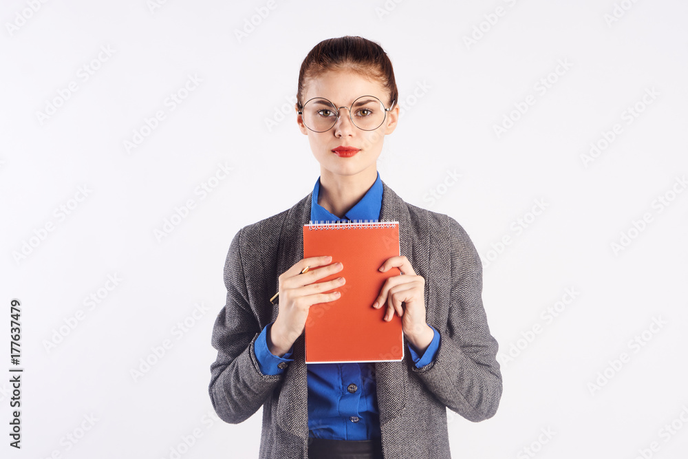 teacher woman with glasses in a notebook on a light background teacher woman with glasses in a notebook on a light background