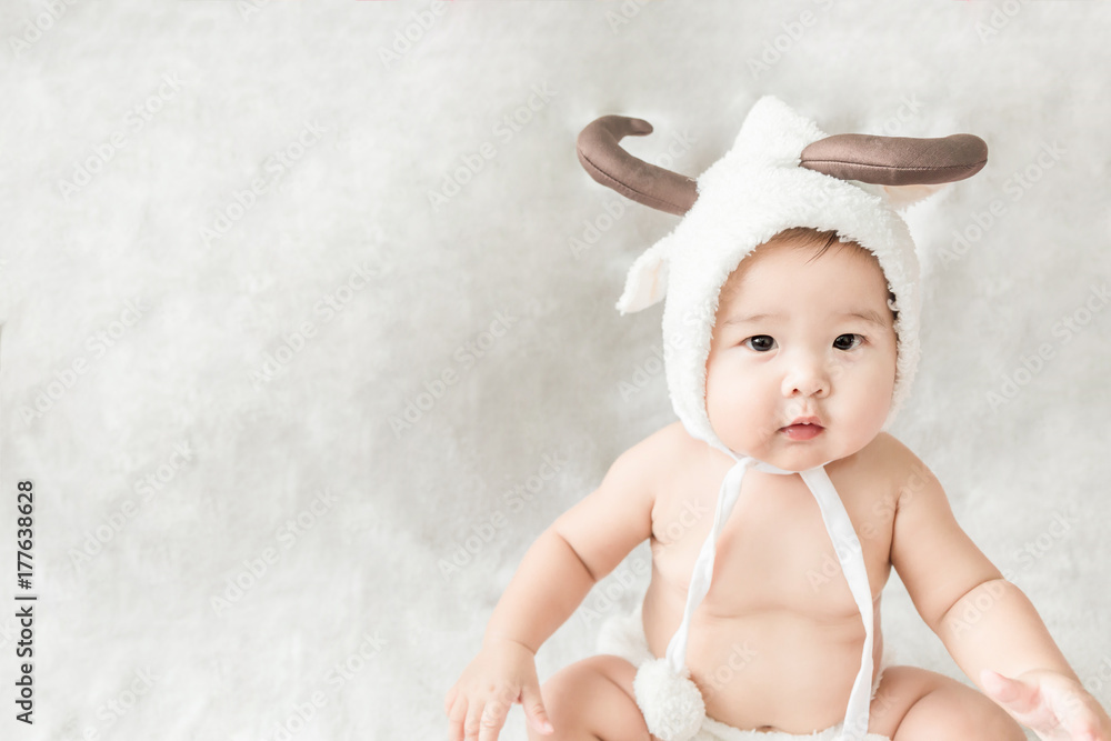 Soft focus Cute Asian male baby sitting on a towel. Blurred background. Soft focus Cute Asian male baby sitting on a towel. Blurred background.