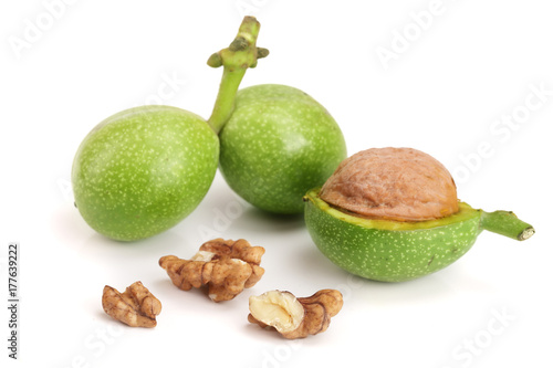 fresh walnuts in peel isolated on white background