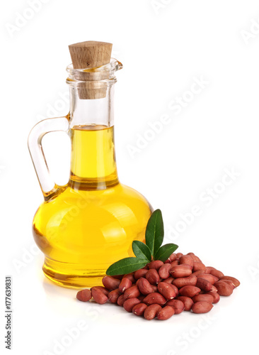 peanut oil in a glass bottle with peanuts