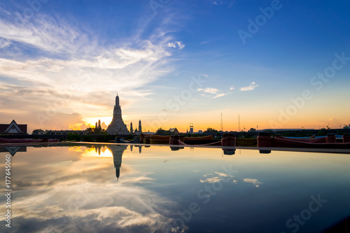 Sunset Wat Arun (Temple of Dawn) and Reflections of Wat Arun Pagoda on glass table is landmark of Attractions's Popular tourists, in bangkok Thailand