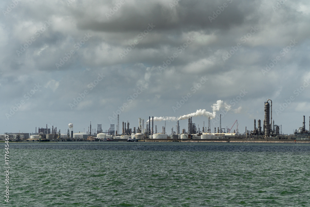 Fototapeta premium Smoke buring off an oil refinery on the gulf coast 