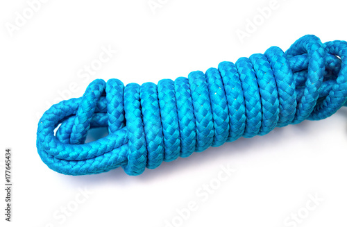 tied up blue skipping rope on white background