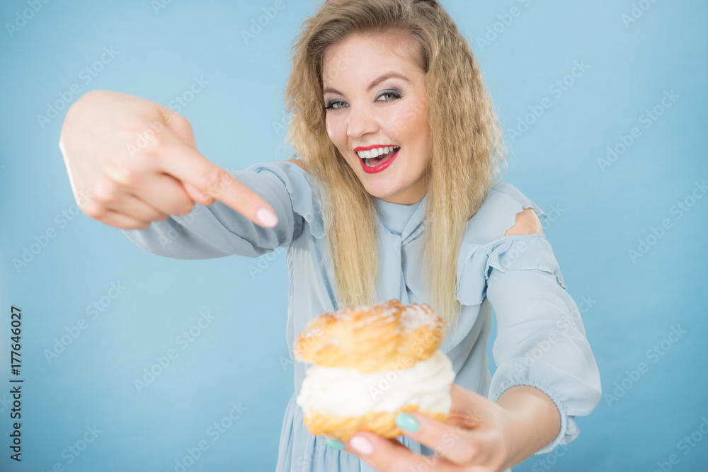 Funny woman holds cream puff cake Funny woman holds cream puff cake