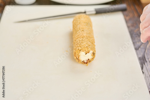 Roll unagi furay on cutting board. Long japanese sushi roll on white cutting board. Traditional japanese food.