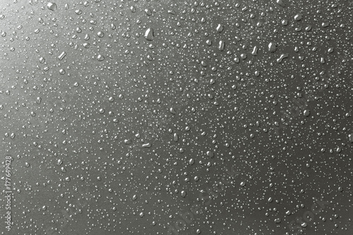 Metal surface with drops of water, silvery background