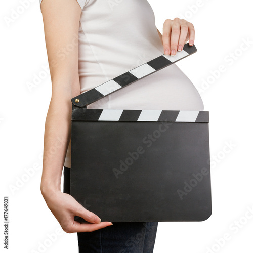 Pregnant woman holding clapperboard