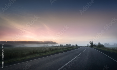 summer rural landscape with blue and red sky  fog and the road. sunrise