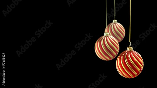 Three christmas balls hanging on ribbon on black background. 4K