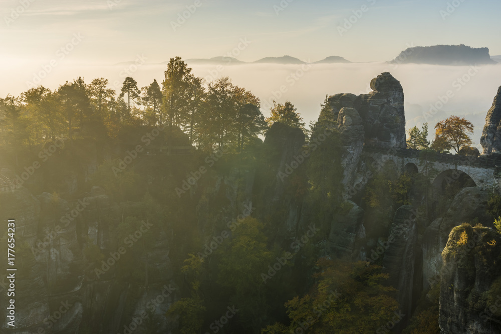 beautiful, foggy sunrise in the Saxon Saxony park, view from the Bastei lookout point.