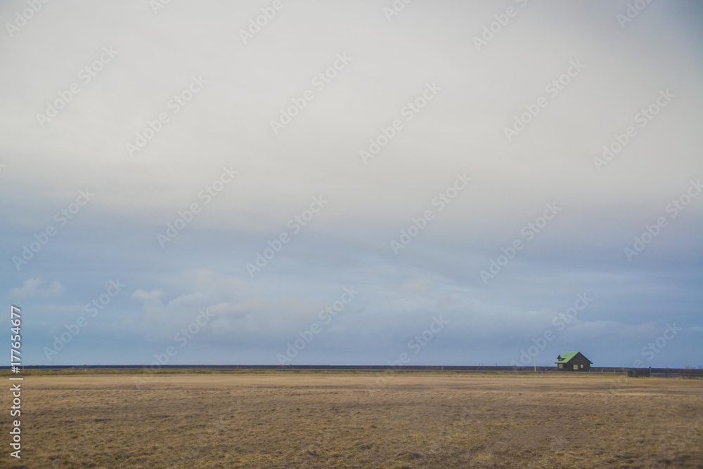 Obraz premium Endless fields of Iceland with a small house
