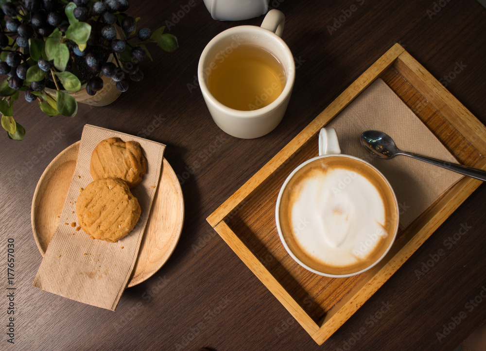 Cookies, tea, and coffee on a dark wooden table Cookies, tea, and coffee on a dark wooden table