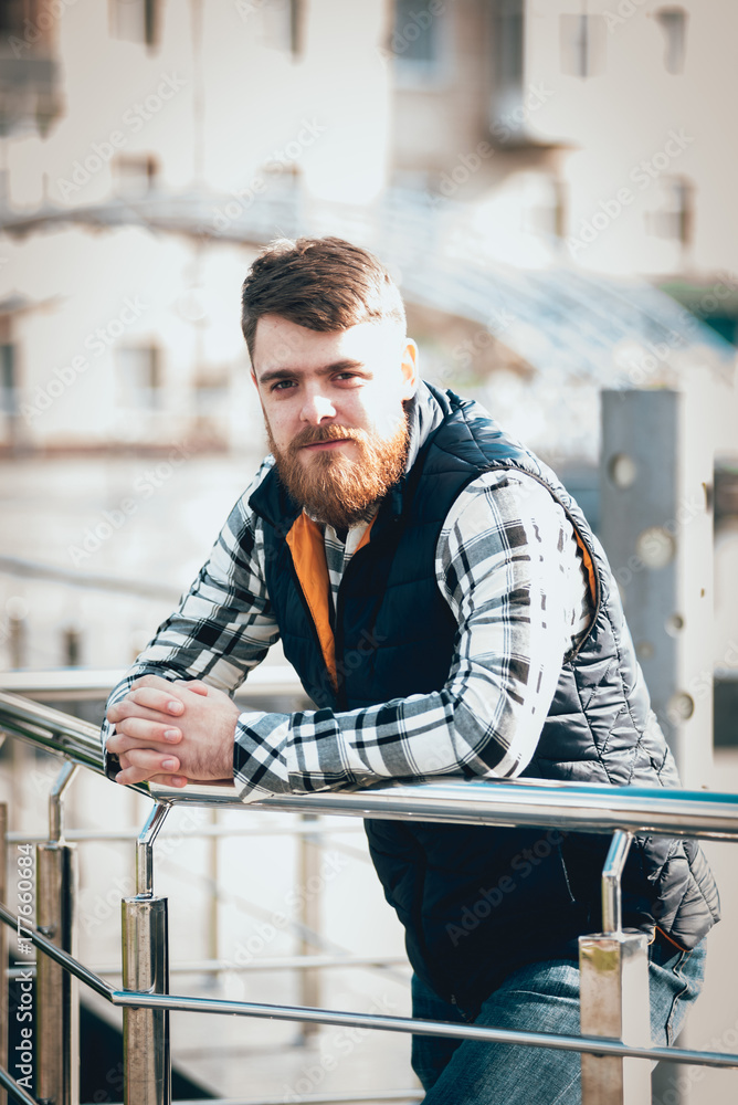 Handsome bearded man in casual clothes posing on camera Handsome bearded man in casual clothes posing on camera