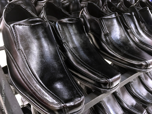 Shiny Men's Black Leather Shoes on Shelf