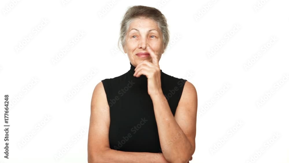 senior serious woman touching her chin thinking hard finally figure out recall something gesturing with index finger over white background. Concept of emotions senior serious woman touching her chin thinking hard finally figure out recall something gesturing with index finger over white background. Concept of emotions