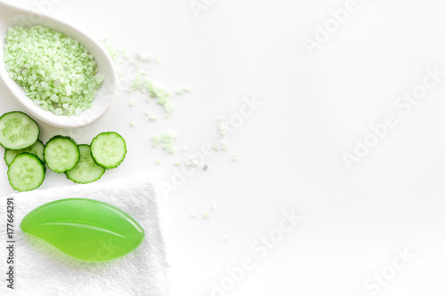 Fresh organic cosmetics with cucumber. Cream, lotion, spa salt on white background top view copyspace