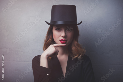 Style and mystique redhead girl in top hat