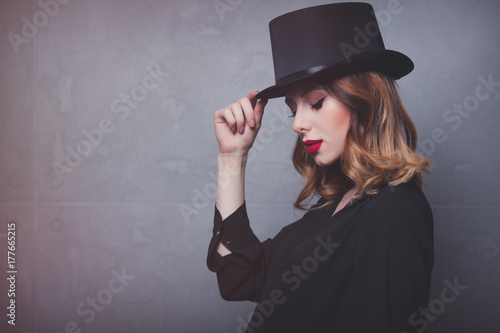 Style and mystique redhead girl in top hat