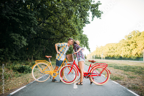 Love couple with vintage bicycle walking in park
