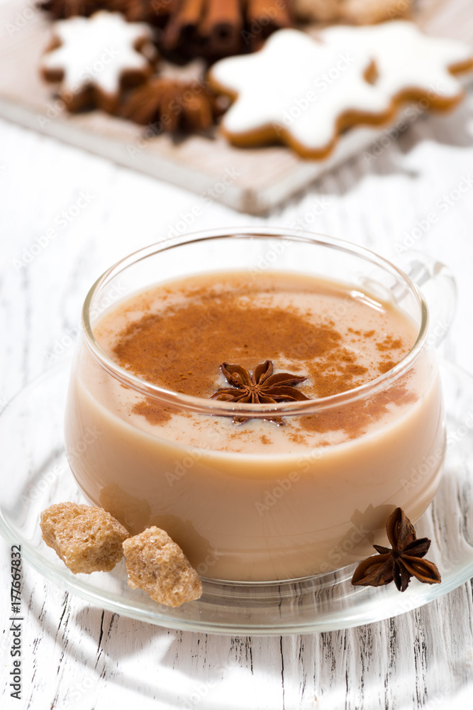 cup of hot spicy masala tea and Christmas cookies on white background, vertical closeup cup of hot spicy masala tea and Christmas cookies on white background, vertical closeup