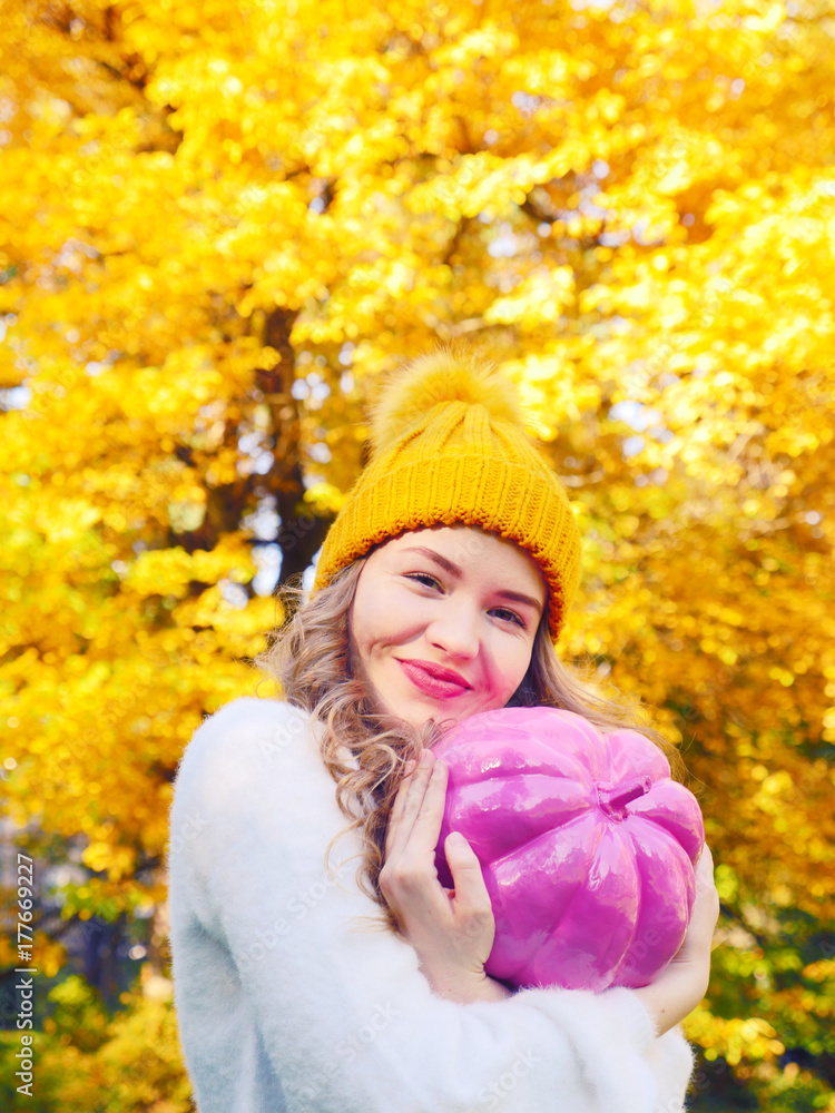 Halloween girl holding art pumpkin on the yellow nature background. Happy girl preparing for the Halloween holidays. Woman with pink pumpkin in the golden forest. Autumn holidays, happy girl pumpkin. Halloween girl holding art pumpkin on the yellow nature background. Happy girl preparing for the Halloween holidays. Woman with pink pumpkin in the golden forest. Autumn holidays, happy girl pumpkin.