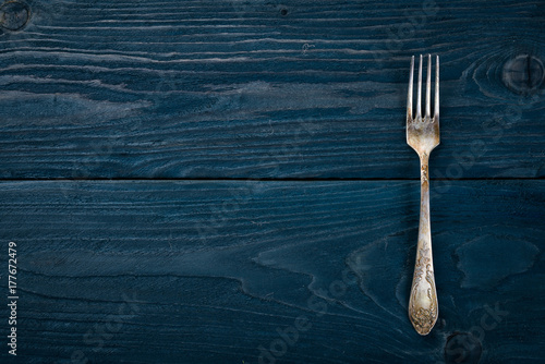 Cutlery. Fork. On a wooden background. Top view. Free space for your text.