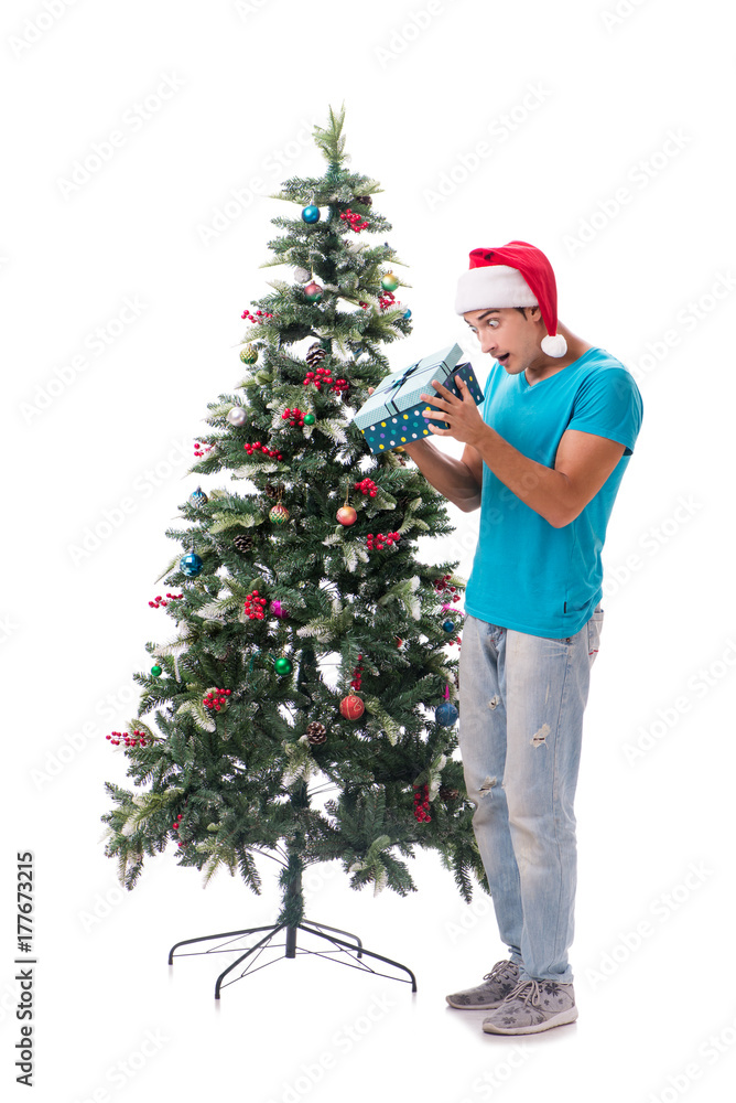 Young man decorating christmas tree isolated on white Young man decorating christmas tree isolated on white