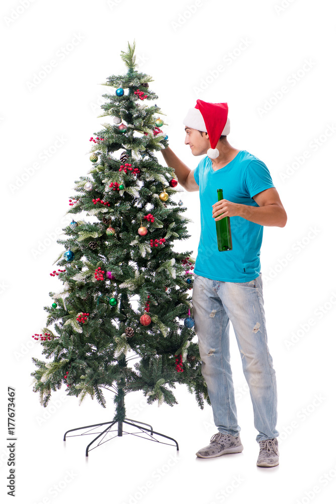 Young man decorating christmas tree isolated on white Young man decorating christmas tree isolated on white