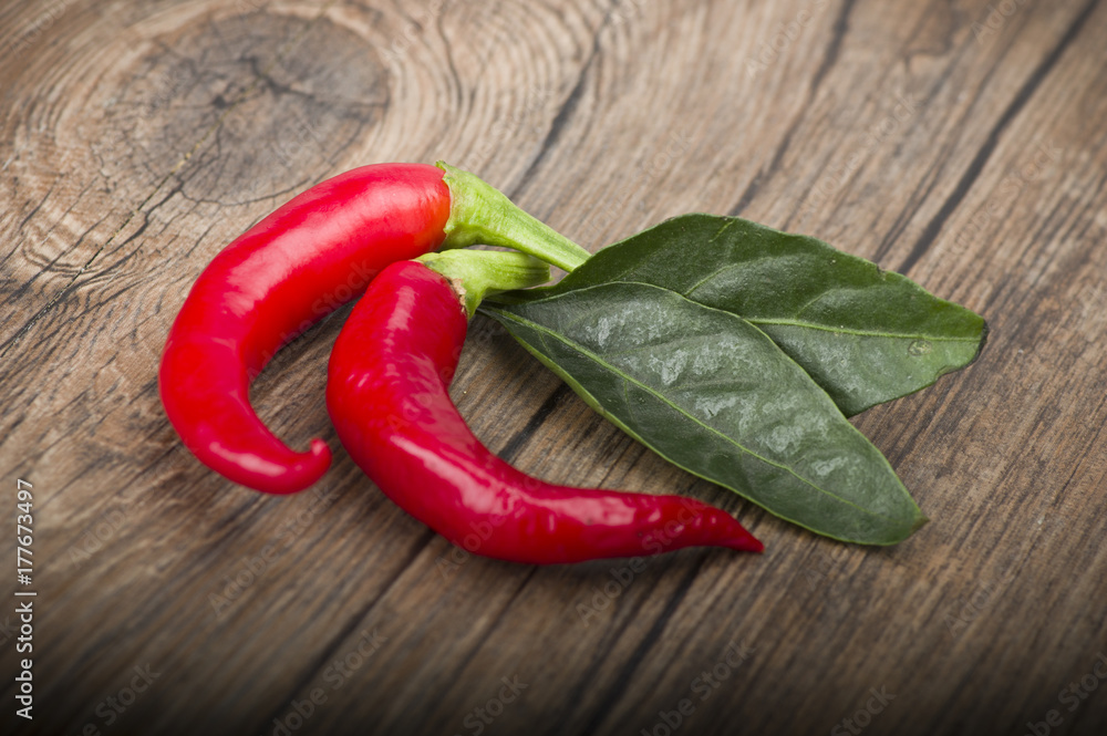 Red chili pepper isolated on a wood background