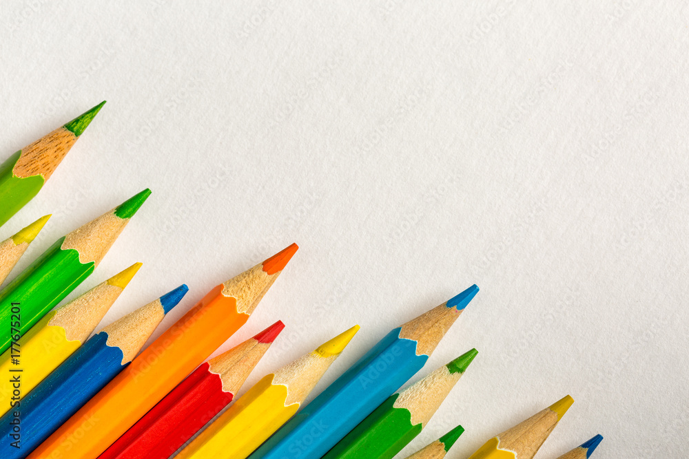 Background with colored pencils and bright paper Background with colored pencils and bright paper