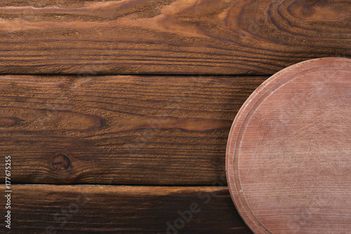 Kitchen wooden board. On a wooden background. Top view. Free space for your text.